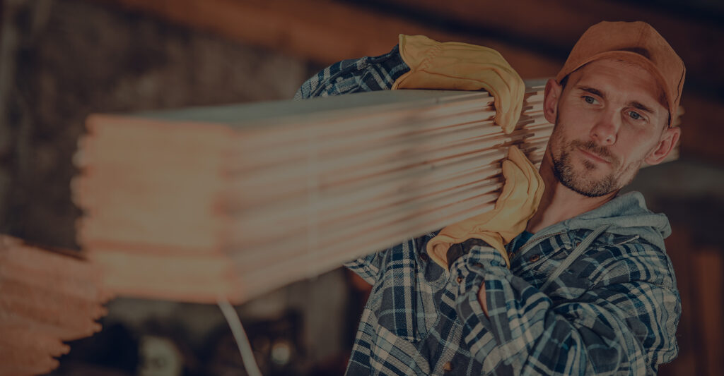 man carrying lumber
