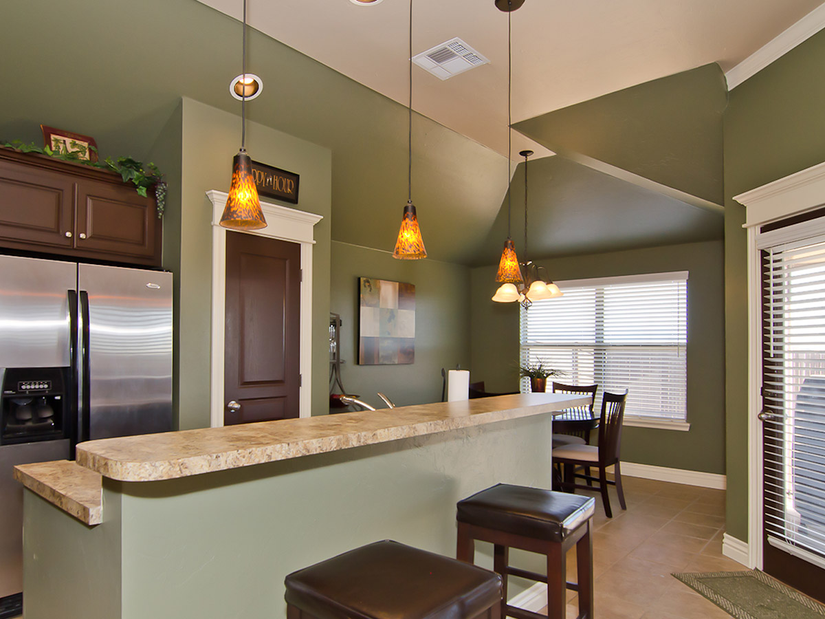 A kitchen with sage green walls.