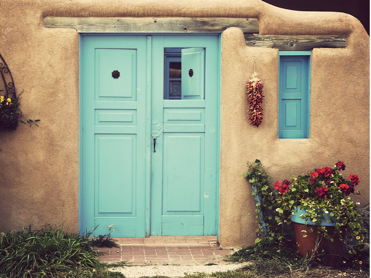 A front door painted with a pastel blue.
