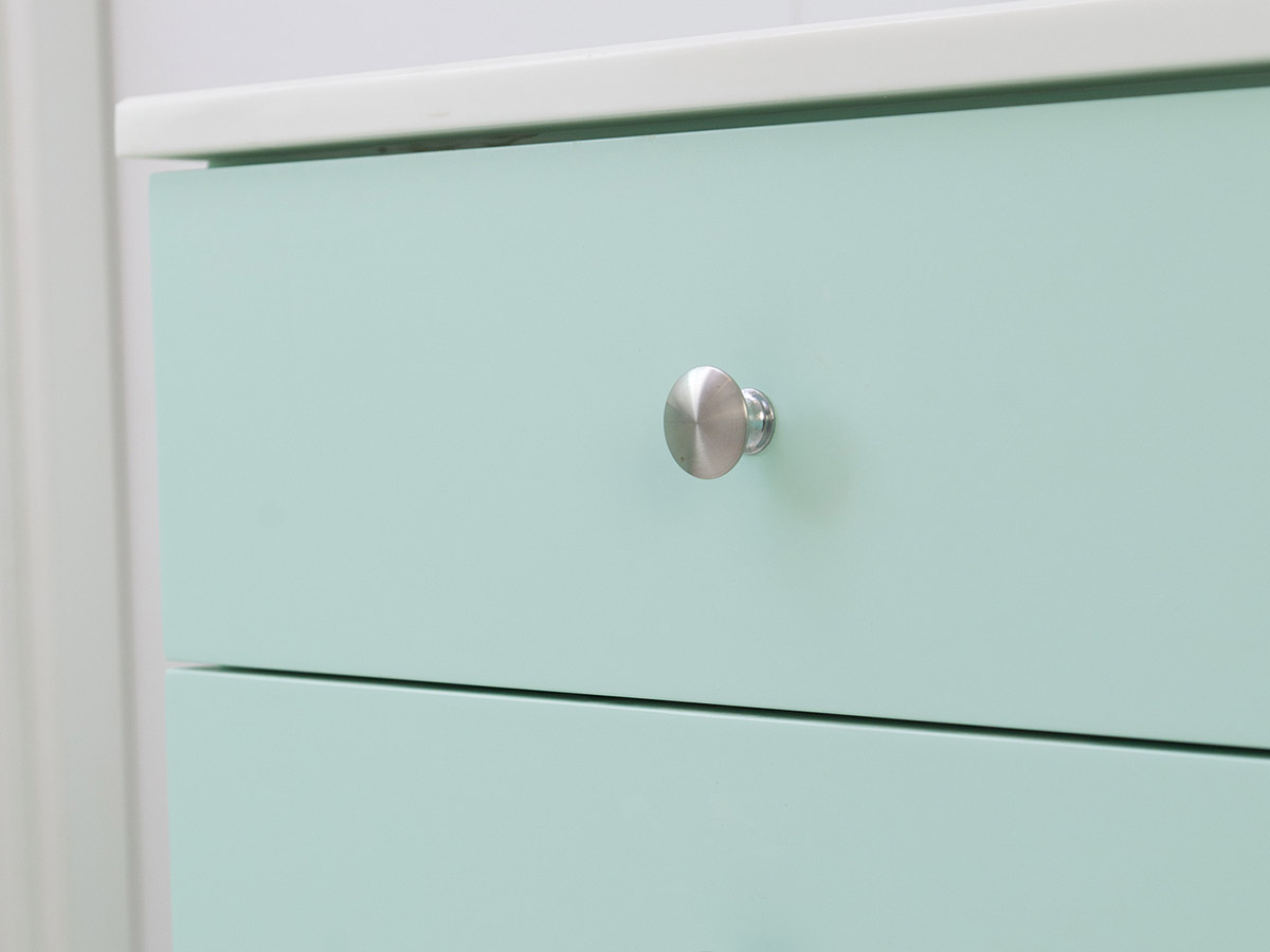 A close-up of the knobs on kitchen cabinet doors.