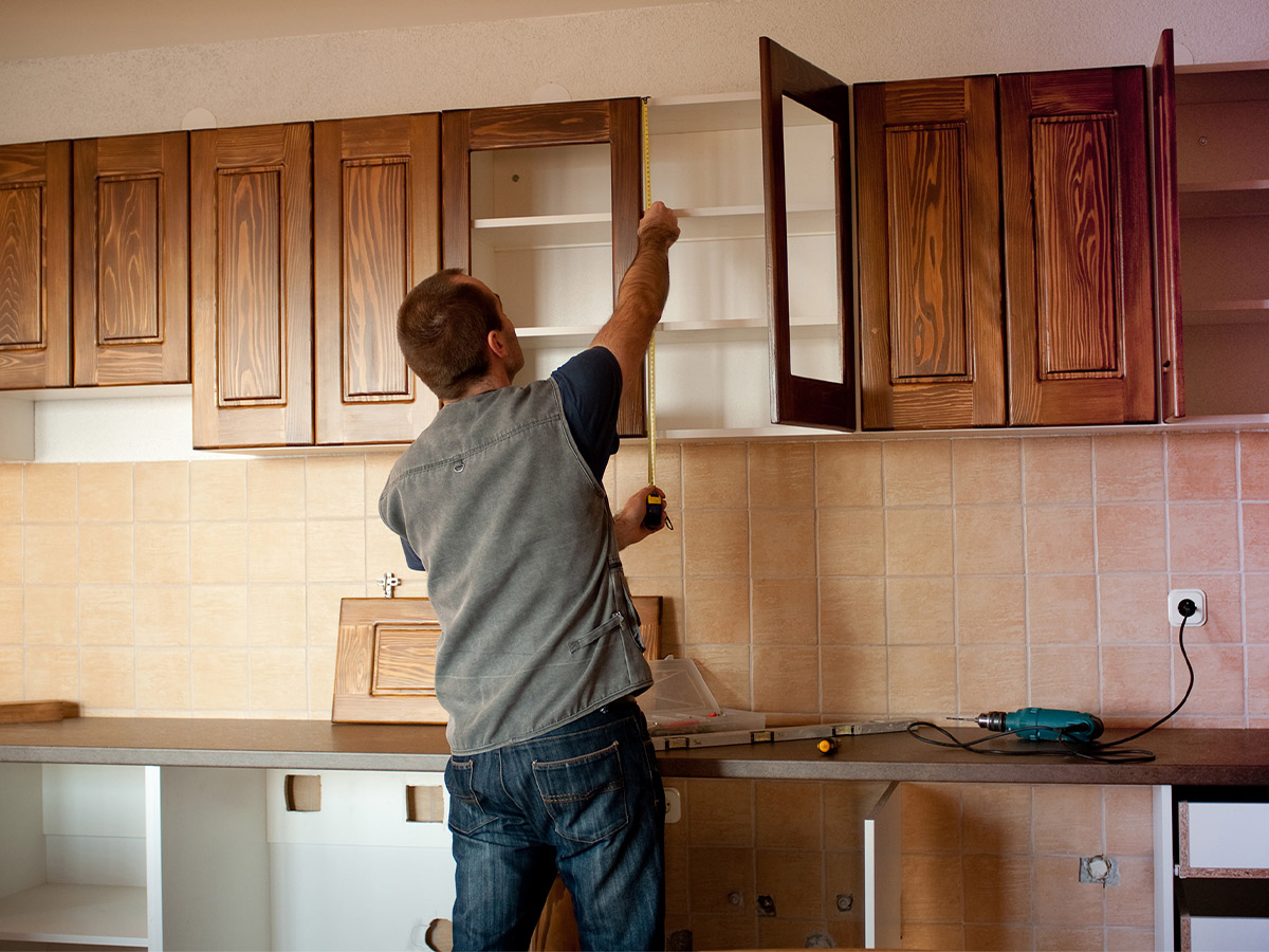 A carpenter working on new cabinet doors.
