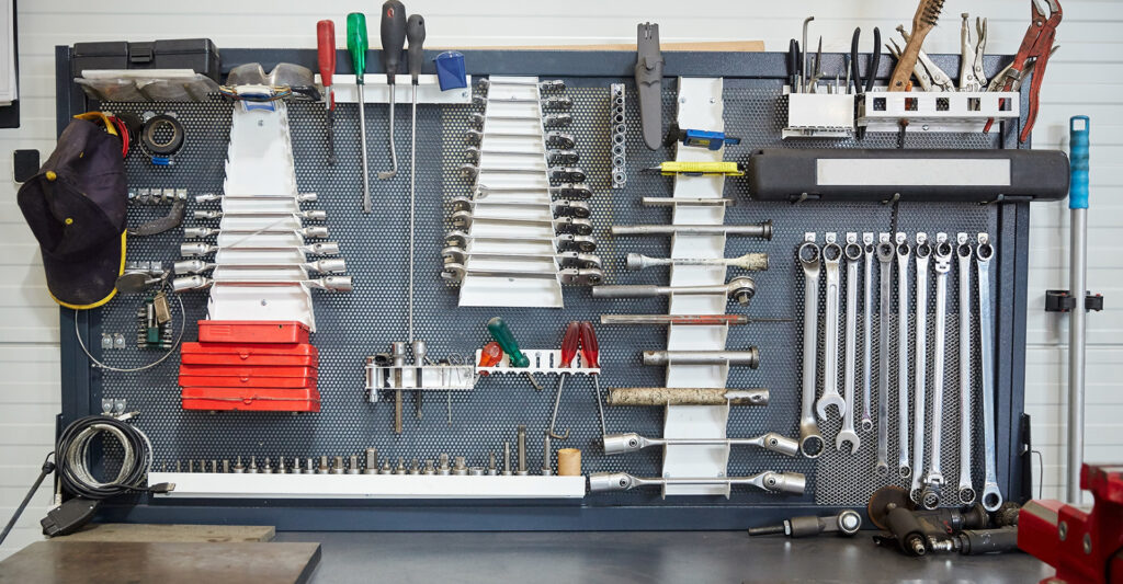 An organized garage wall with tools and table