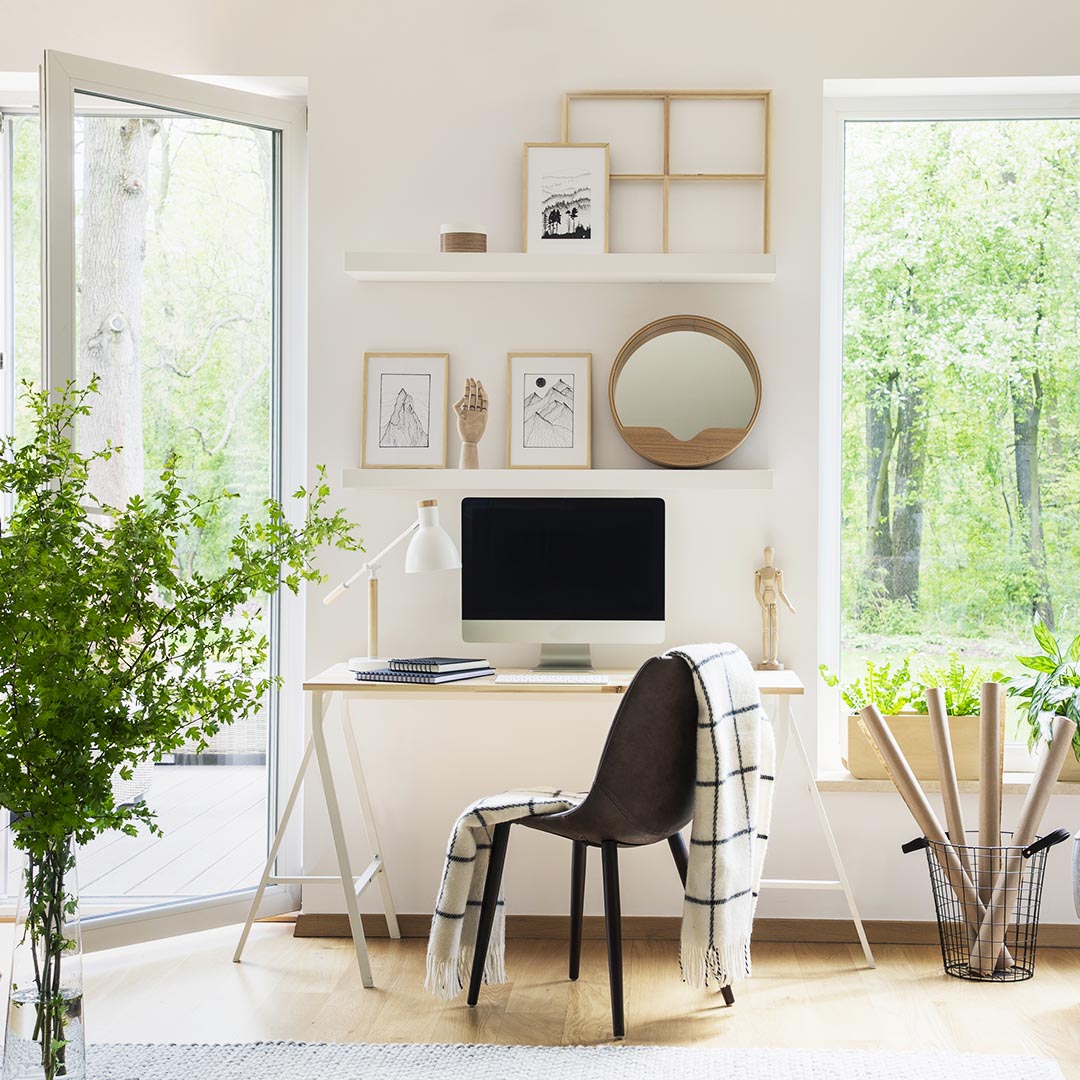 desk and chair with floating shelves above it