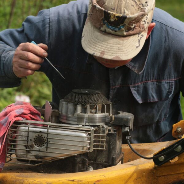 man repairing his own small engine